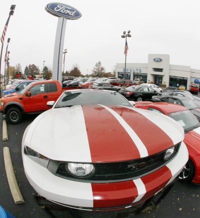 A Mustang is displayed on a raiser in the lot of a Ford dealership in Wexford, Pa., last week. Ford Motor Co. reported Monday it made nearly $1 billion in the third quarter.  (Associated Press / The Spokesman-Review)