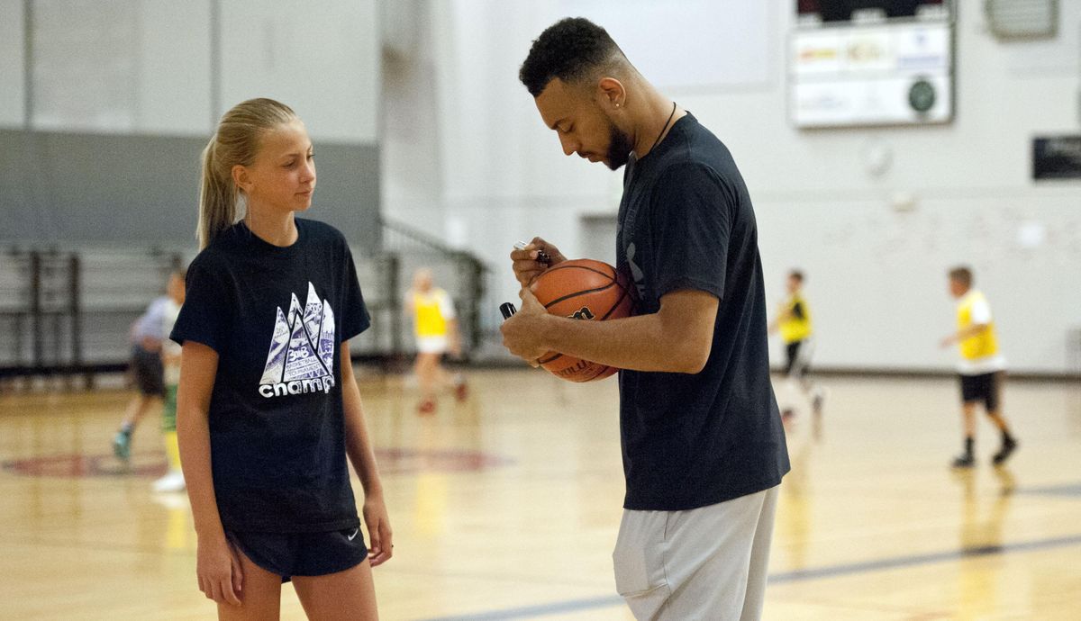 Avery Waddington,13, of Rathdrum, gets her basketball signed by former Gonzaga star Nigel Williams-Goss during his annual basketball camp at The Hub in Liberty Lake on Tuesday, August 6, 2019. (Kathy Plonka / The Spokesman-Review)