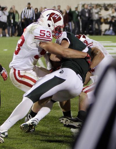 Spartans receiver Keith Nichol bulls through Wisconsin defenders for winning TD. (Associated Press)