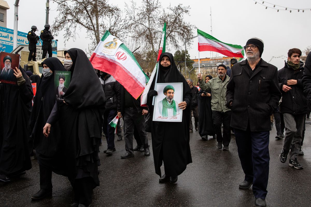 A woman holds a photo of the new supreme leader, Mojtaba Khamenei, on Friday during a march to mark Quds Day, an event held annually by the Iranian government to oppose Israel, on the last Friday of Ramadan. (New York Times)
