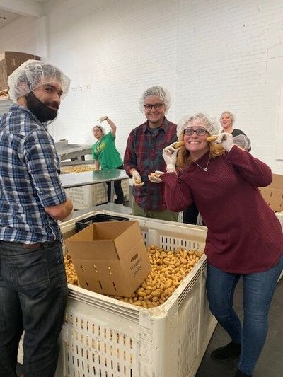 Alliant Insurange Services volunteers have fun as they help pack food at Northwest Harvest. The firm earned a  2020 Make More Happen Award from Liberty Mutual and Safeco Insurance for its philanthropic efforts. The award includes a $5,000 donation for Northwest Harvest. (Courtesy)
