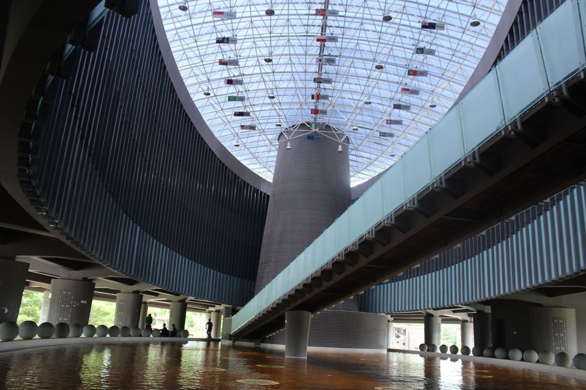 The atrium in the Tsunami Museum in Banda Aceh, Indonesia, which also serves as a public park. At the top are the flags of the countries that assisted in the tsunami recovery with the word “Peace” inscribed below.