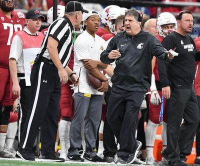 Washington State Cougars head coach Mike Leach speaks with an official during the first half of the 2018 Alamo Bowl on Friday, December 28, 2018, at the Alamo Dome in San Antonio, TX. (Tyler Tjomsland / The Spokesman-Review)