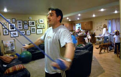 
Dave Miller, of Post Falls, works out at his home. He was in a serious soccer accident last May and says his recovery since then has been a miracle. 
 (Kathy Plonka / The Spokesman-Review)