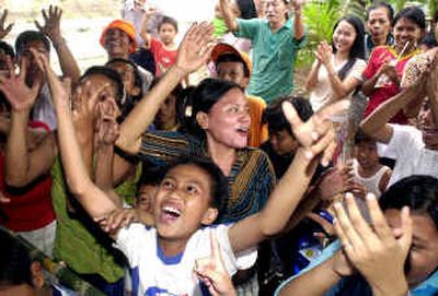 Supporters cheer tallies for presidential candidate Susilo Bambang Yudhoyono in Jakarta on Monday.
(Associated Press / The Spokesman-Review)