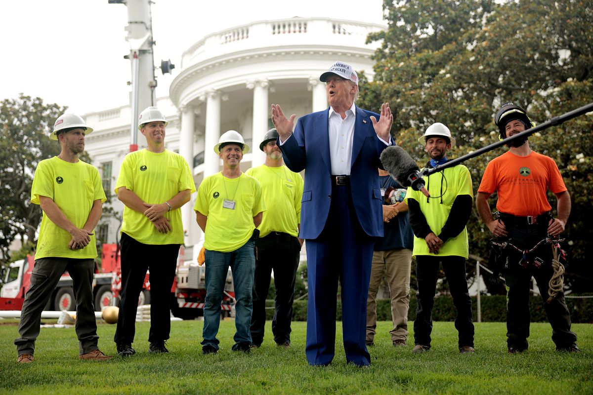 Standing with workers before they install a new flag pole on the South Lawn, U.S. President Donald Trump talks with journalists outside the White House on June 18, 2025, in Washington, D.C. Trump said that he personally paid for the pole and another just like it on the North Lawn and their installations. (Chip Somodevilla/Getty Images/TNS)  (Chip Somodevilla)