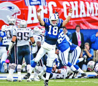 
Indianapolis Colts quarterback Peyton Manning (18) celebrates running back Joseph Addai's three-yard touchdown run. 
 (Associated Press / The Spokesman-Review)