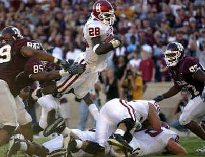 
Oklahoma running back Antonio Perkins dives into the end zone for a second-quarter touchdown Saturday in College Station, Texas. 
 (Associated Press / The Spokesman-Review)