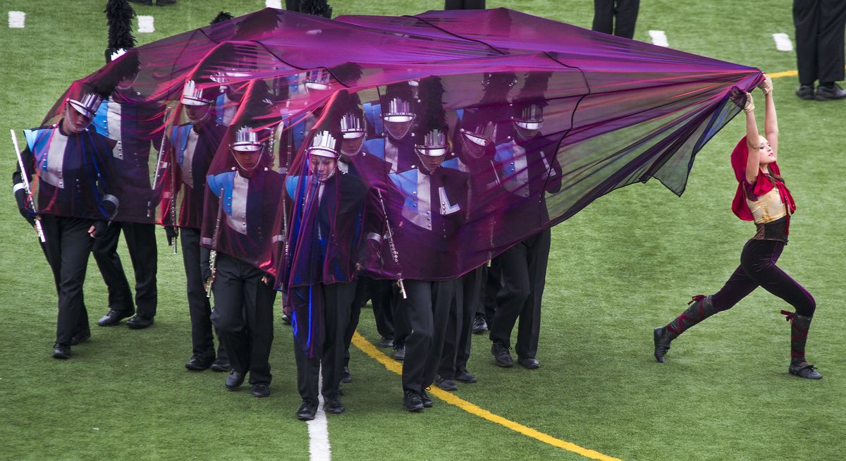 Dressed as Little Red Riding Hood, Emily Pozzi with the Central Valley High School color guard uncloaks the marching band flute section during a preliminary performance at the Sounds of Thunder marching band competition in Joe Albi Stadium. (Colin Mulvany)