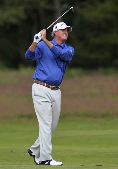 Russ Cochran, one of three atop the leaderboard, hits a shot on the fourth hole during the third round of the Senior British Open. (Associated Press)