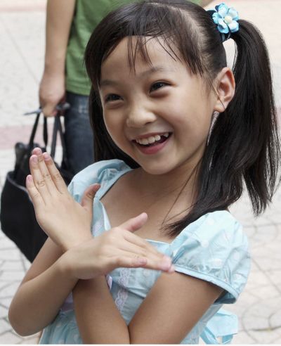 In this photo released by China’s Xinhua News Agency, Lin Miaoke, a 9-year-old girl who performed at the opening ceremony of the Beijing Olympics on the day before, returns to the Xizhongjie Primary School of Dongcheng District in Beijing on Saturday. (Associated Press / The Spokesman-Review)