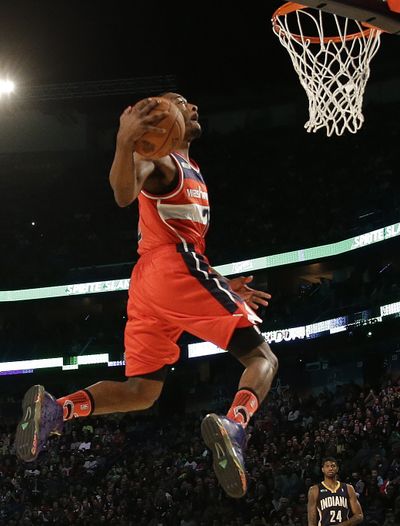 John Wall of the Washington Wizards slam dunks during the skills competition at the NBA All-Star festivities in New Orleans. (Associated Press)