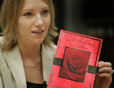 Jessica Ong, product manager for valentines, holds last years best-selling Valentine's card at Hallmark in Kansas City, Mo. 
 (Associated Press / The Spokesman-Review)