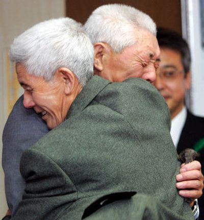 
Former Japanese soldier Ishinosuke Uwano, foreground, hugs his younger brother Ushitaro Sadate as they reunite Thursday for the first time in 63 years  in Morioka, northern Japan. 
 (Associated Press / The Spokesman-Review)