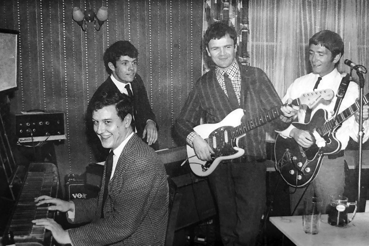 Seen in a snapshot from the 1960s, John Travers, far right, plays a guitar with a group of pub entertainers. Travers now lives in Spokane Valley and is mostly retired, but he still dabbles in music by writing his own songs.  (Photo courtesy of John Travers)