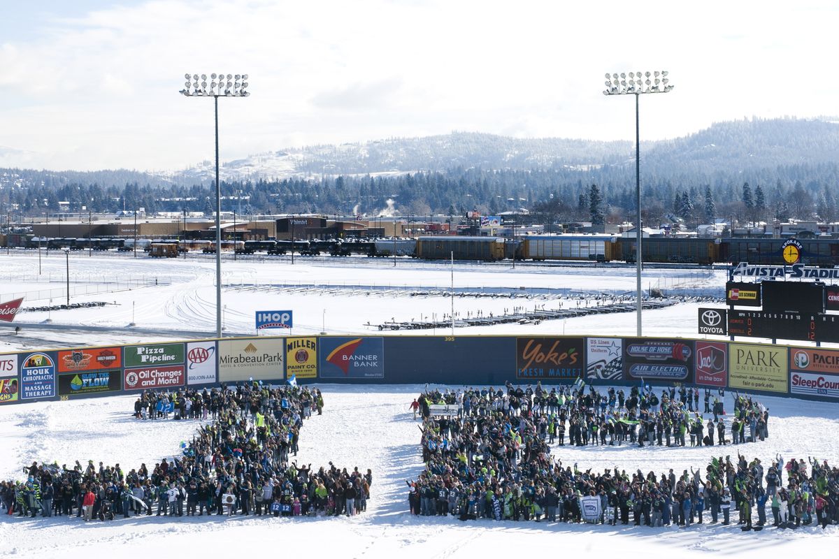 Local Seattle Seahawks fans gather Friday on the field at Avista Stadium to form a giant “12.” (Tyler Tjomsland)