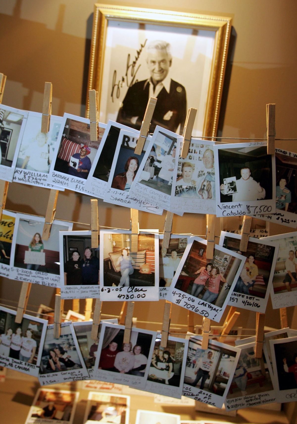 FILE -- A photograph of Bob Barker hangs behind snapshots of winning "The Price is Right" contestants in the lobby of the Farmer's Daughter Hotel, across the street from CBS Studios in Los Angeles in June 2006. Barker, the good-natured host of "The Price Is Right," and one of the country's best-known advocates for animal rights, died at home in Los Angeles on Aug. 26, 2023. He was 99. (J. Emilio Flores/The New York Times)..  (J. Emilio Flores)