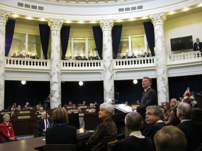 Gov. Butch Otter acknowledges business leaders in the balcony during his State of the State message to a joint session of the Idaho Legislature on Monday. (Betsy Russell)