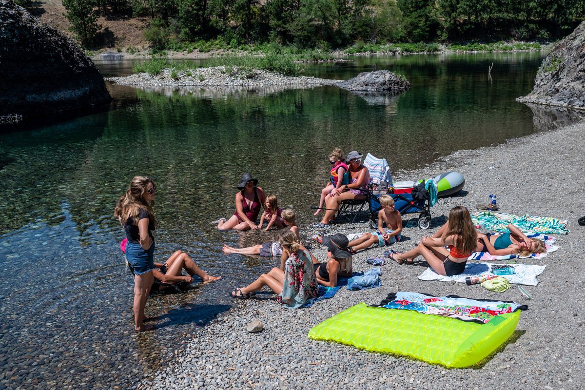 Friends gather at a secluded Coyote Rocks beach and swimming area in Spokane Valley. (COLIN MULVANY/THE SPOKESMAN-REVIEW)