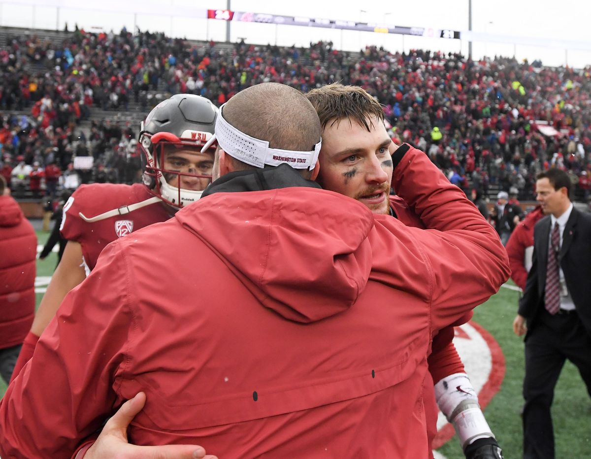 WSU defensive coordinator Alex Grinch embraces Washington State Cougars quarterback Luke Falk (4) after they defeated Stanford during the second half of a college football game on Saturday, November 4, 2017, at Martin Stadium in Pullman, Wash. WSU won the game 24-21. (Tyler Tjomsland / The Spokesman-Review)
