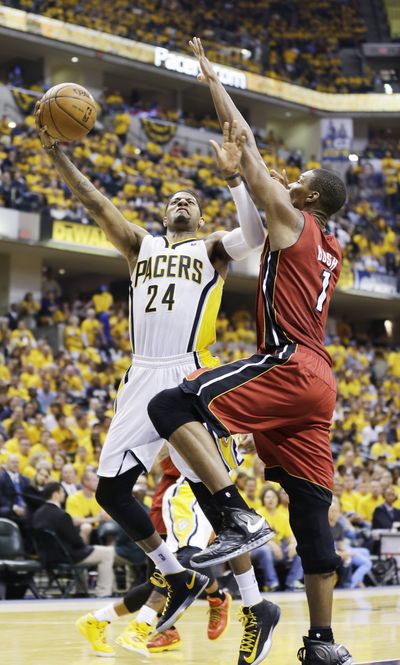 Pacers forward Paul George goes up for a shot against Heat center Chris Bosh. George scored 28 points. (Associated Press)