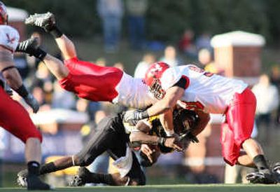 
Eastern Washington's Jason Belford, left, and Josh Jacobson gang up on quarterback Armanti Edwards on Saturday. Associated Press
 (Associated Press / The Spokesman-Review)