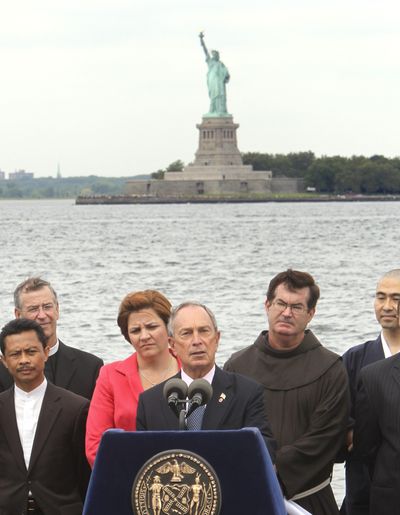 New York City Mayor Michael Bloomberg, center,  voices  his support for a  mosque near ground zero Tuesday.  (Associated Press)