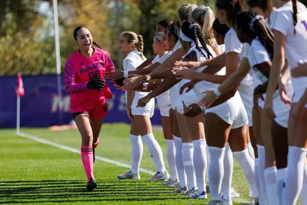 UW’s Mia Hamant, high-fiving her teammates on Oct. 13, 2024, died earlier this month at age 21. (Caean Couto/University of Washington)
