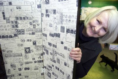 
Habitat Spokane Builders Surplus store volunteer Theodora Sallee shows a bifold screen she refurbished with stain and old wallpaper. 
 (CHRISTOPHER ANDERSON / The Spokesman-Review)