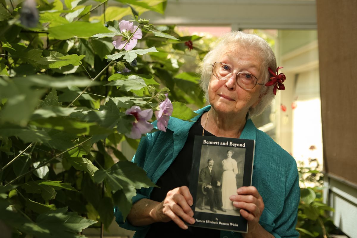 Fran Wicht poses with a copy of her recently-completed book, "Bennett and Beyond," in her sunroom on July 8, 2021. Wicht's newest book is on her father but is far from the first book she authored, and it is actually book number four in her lineup from Spokane-based Gray Dog Press.  (Libby Kamrowski/ THE SPOKESMAN-REVIEW)