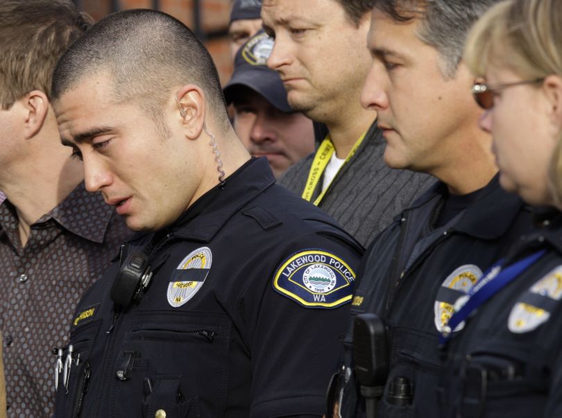 Lakewood police  officers listen during a Nov. 30 news conference about the shooting of four of their colleagues in nearby Parkland,  Wash.  (File Associated Press)