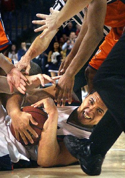 
Bulldogs center J.P. Batista battles for possession Saturday while on the floor at the McCarthey Athletic Center court. 
 (Brian Plonka / The Spokesman-Review)