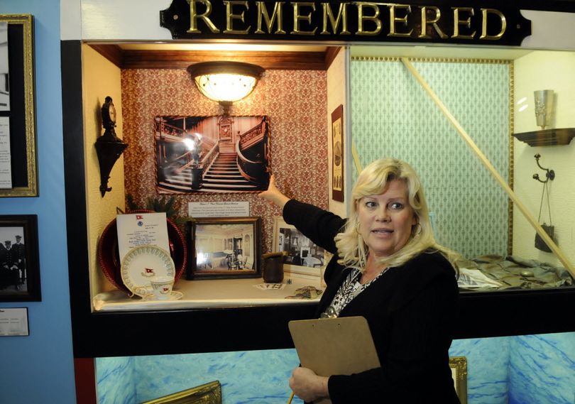 Spokane Valley Heritage Museum Executive Director Jayne Singleton highlights a photograph of Titanic's grand staircase on display in the museum's exhibit about the April 15, 1912, sinking of the ship.  (Dan Pelle)
