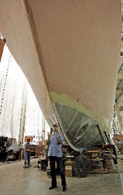 
Burger Boat President and CEO David Ross stands in front of one of the large yachts the company is working on.  
 (Associated Press / The Spokesman-Review)