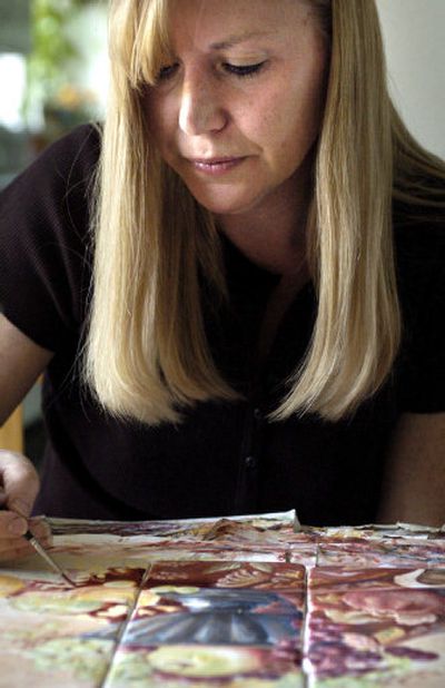 
Jacquie Masterson paints on marble pieces at her home in Spokane Valley.
 (The Spokesman-Review)
