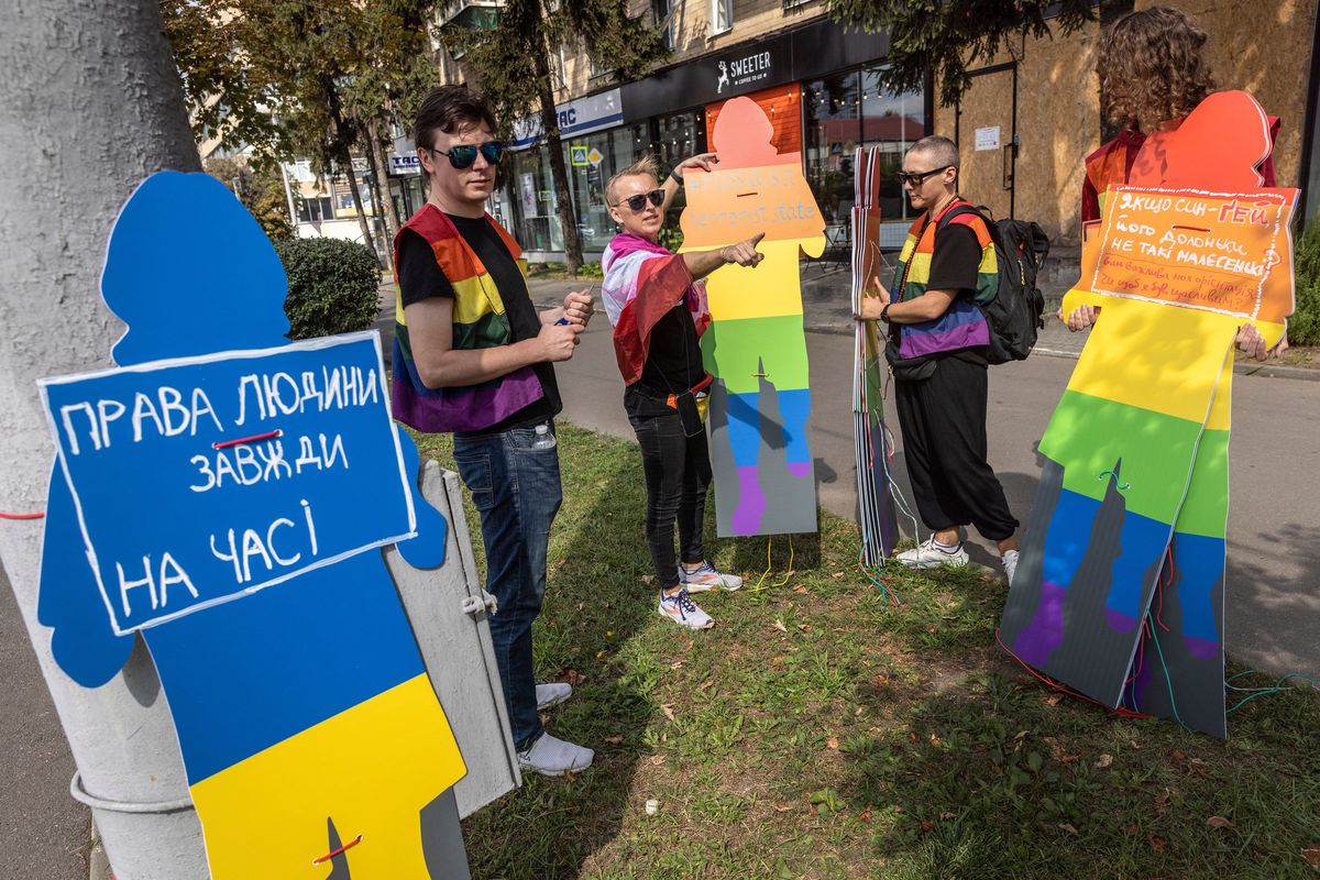 Ukrainian LGBTQ activists gather with signs during a "Kharkiv Pride" march in central Kharkiv, Ukraine on Saturday, Sept. 2, 2023. The signs, from left to right, read "Human Rights Are Always Relevant", "Russia Is A Terrorist State", and "Do you care about my orientation or do you want me to be happy".(David Guttenfelder/The New York Times)  (DAVID GUTTENFELDER)