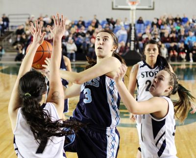Central Valley's Sydney Emory, middle, drives to the basket against Skyview's Stephanie McDonagh, left and HJ Adams, right, during action in the 4A Girls State Basketball Tournament on Saturday in the Tacoma Dome. Skyview defeated Central Valley 46-43 on a last second shot. (Patrick Hagerty / The Spokesman-Review)