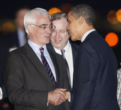 President Barack Obama is greeted by Britain’s Chancellor of the Exchequer Alistair Darling in London on Tuesday. At center is Charge d’Affaires Richard LeBaron.  (Associated Press / The Spokesman-Review)