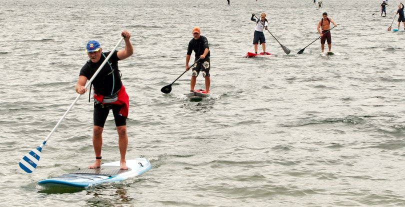 Lee Murray, of Gig Harbor, Wash.,  leads a group of stand-up paddleboarders as they near the end of the race.  (ELLEN M. BANNER)
