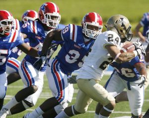 Louisiana Tech defensive back Justin Goodman, left, linebacker Jay Dudley, second from left, running back Roosevelt Falls (39) and running back Myke Compton (26) try to stop Idaho wide receiver Justin Veltung (24) during the first half of an NCAA college football game in Ruston, La., on Saturday, Oct. 16, 2010. (Terrance Armstard / The News-star)