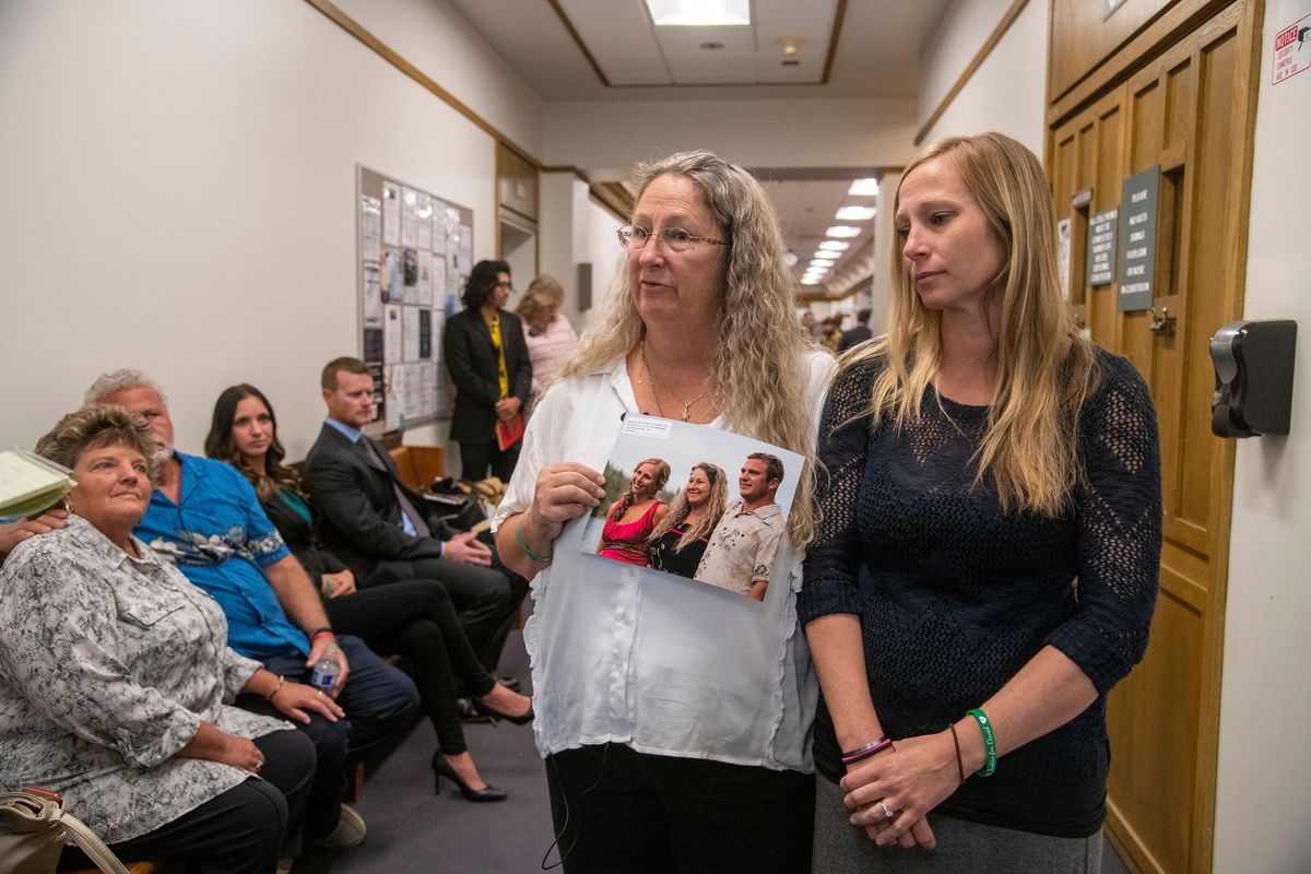 Debbie Novak, center, and her daughter, Crystal Jenkins, stand outside the courtroom and talk to media while holding a photo that includes Novak’s son, David, on Thursday at the Spokane County Courthouse.  (Jesse Tinsley/THE SPOKESMAN-REVIEW)