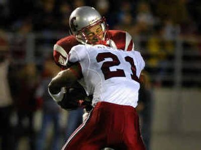 
WSU running back Allen Thompson grimaces as Stanford's Oshiomogho Atogwe puts a lick on him in the second quarter. Thompson finished with 78 yards on nine carries.
 (Christopher Anderson/ / The Spokesman-Review)