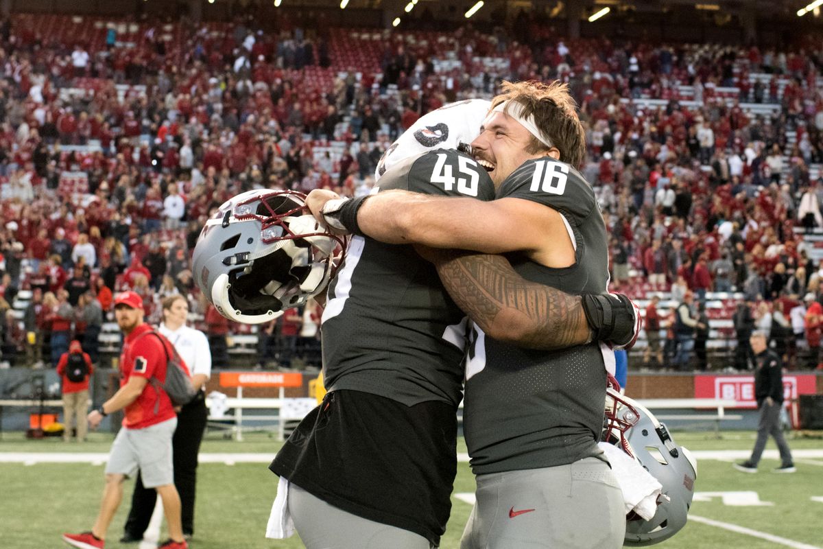 Washington State Cougars quarterback Gardner Minshew (16) and defensive lineman Logan Tago (45) celebrate defeating Utah during the second half of a college football game on Saturday, September 29, 2018, at Martin Stadium in Pullman, Wash. WSU won the game 28-24. (Tyler Tjomsland / The Spokesman-Review)