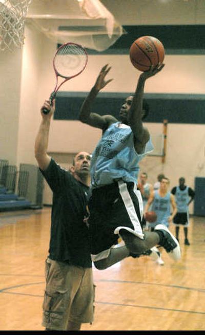 
William Davis of the Central Valley Bears drives over coach Rick Sloan at practice Dec. 5. He scored a game high 18 points in the Bears 62-39 victory over East Valley the night before. 
 (J. BART RAYNIAK / The Spokesman-Review)
