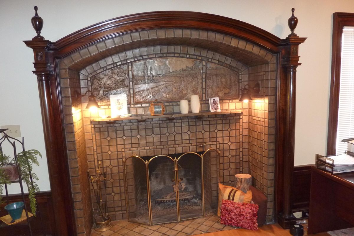A fireplace installed in the original library features carved wood, terra cotta carving, recessed lighting and ornate tile, which Binkley imported from Italy, according to previous owner (Stefanie Pettit / The Spokesman-Review)