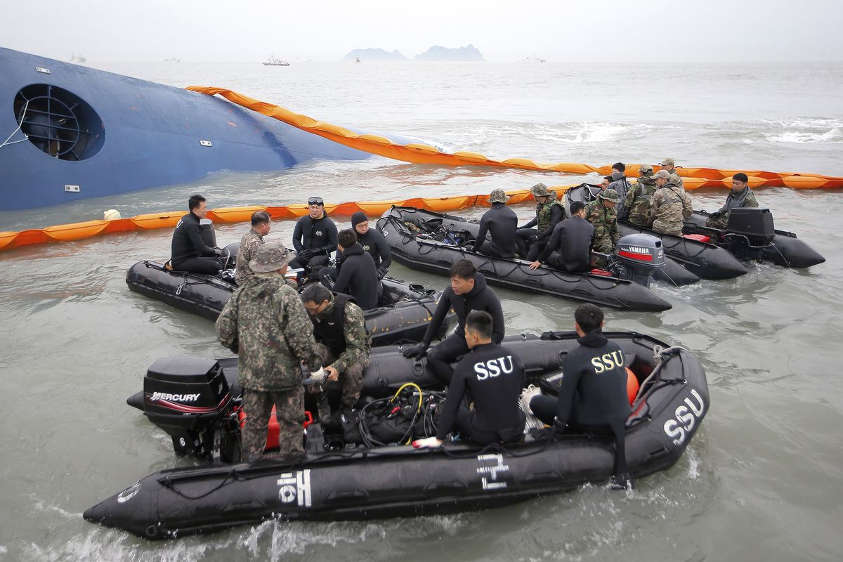 South Korean rescue team members prepare to search a capsized ferry off South Korea’s southern coast Thursday. (Associated Press)