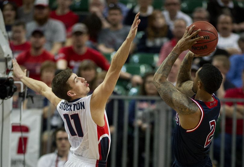 Gonzaga Bulldogs guard David Stockton (11) defends St. Mary’s Gaels guard Paul McCoy (2) as he takes a shot during the second half of a WCC tournament semifinal men’s college basketball game, Monday, March 10, 2014, in Las Vegas, Nevada. (Colin Mulvany)