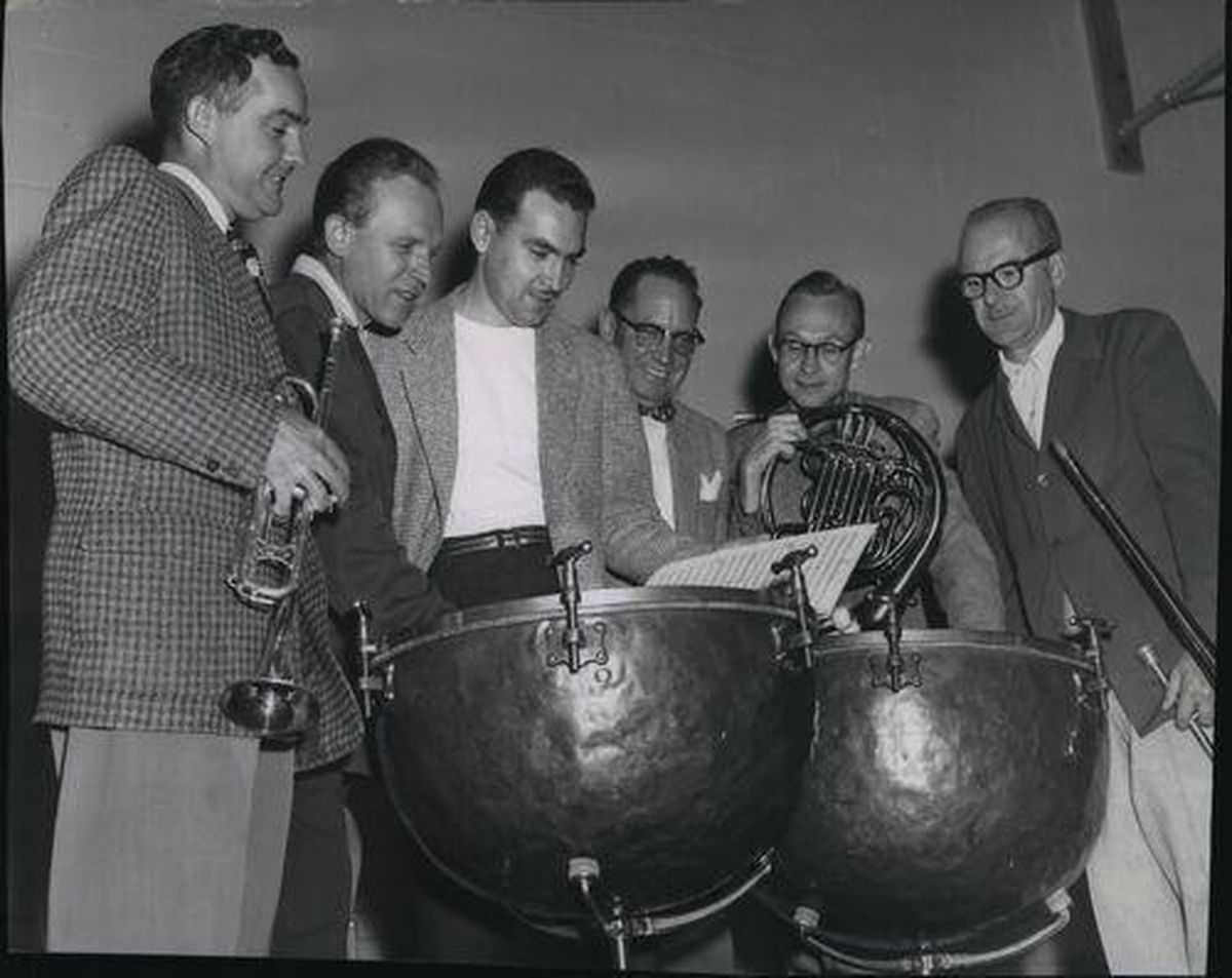 In this 1954 photo, going over the score with the composer are principles of those sections: left to right, John Harris, trumpet; Whelan, Hartley, Fred Hartley, tympani; Wendell Exline, horn; Harold Treadwell, trombone. Harold Paul Whelan was set to raise his baton at the start of the Spokane Philharmonic orchestra