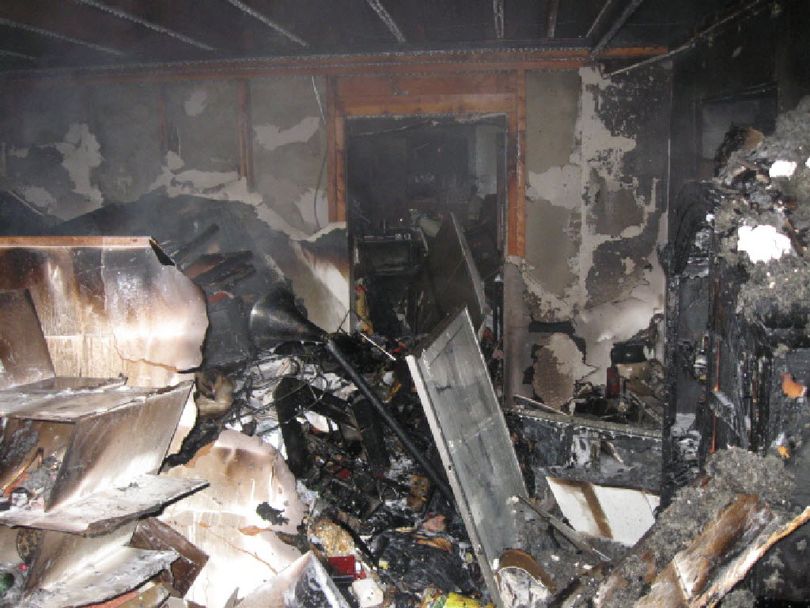 This photo shows the interior of a house on the 13200 block of East 24th Avenue that burned. Piles of charred, shoulder- high debris had to be removed. The damage is estimated at $160,000.  (Photo courtesy Spokane Valley Fire Department)