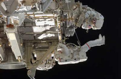 
In this photo provided by NASA,  Atlantis astronauts Jim Reilly, bottom, and John 